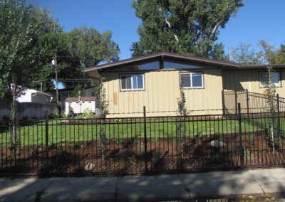 Side of home with new fence and lawn